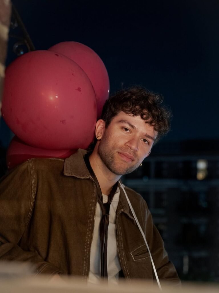 Headshot of Christian Collazo at night with balloons
