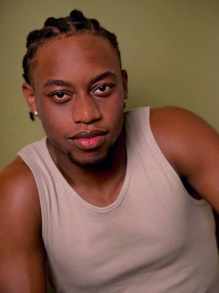 Headshot of Isaiah Robinson on a green backdrop